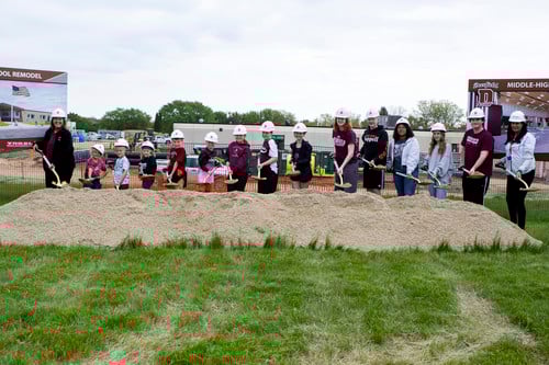 Thirteen students, one from each grade K-12, helped mark the occasion